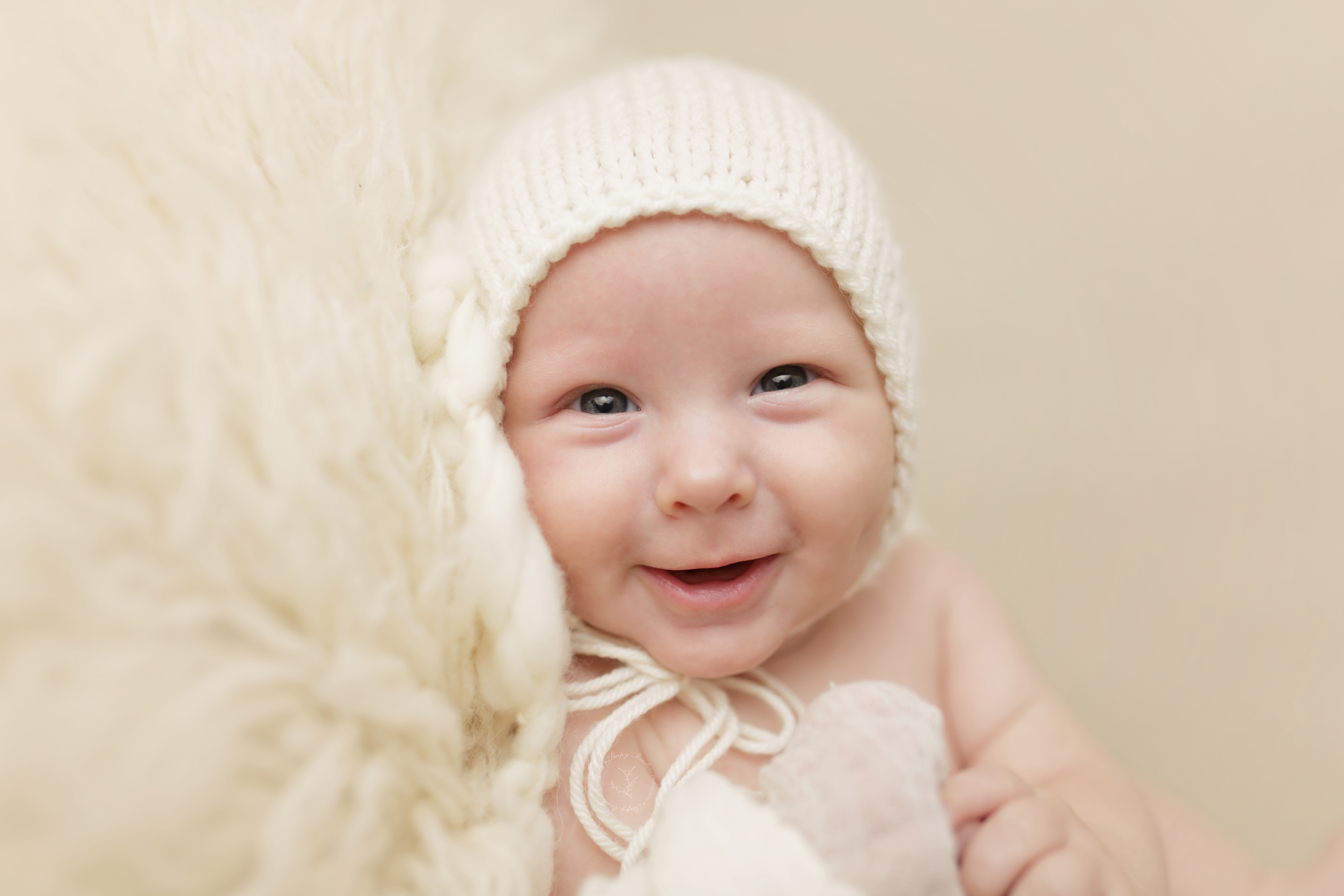 Evan wears a bonnet for his 3 month old photoshoot.