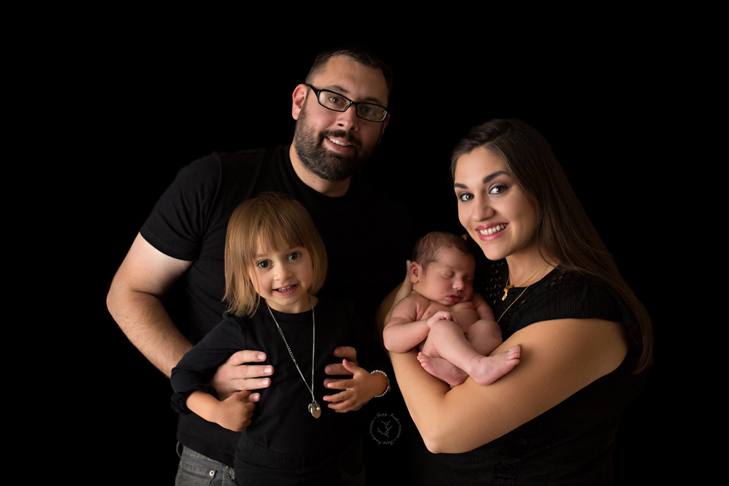 Beautiful family picture taken during a newborn session in Milwaukee, WI with sibling.