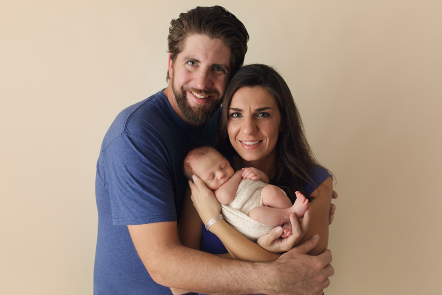 Carter takes a picture with his mom and dad for his newborn session in Brookfield, WI.