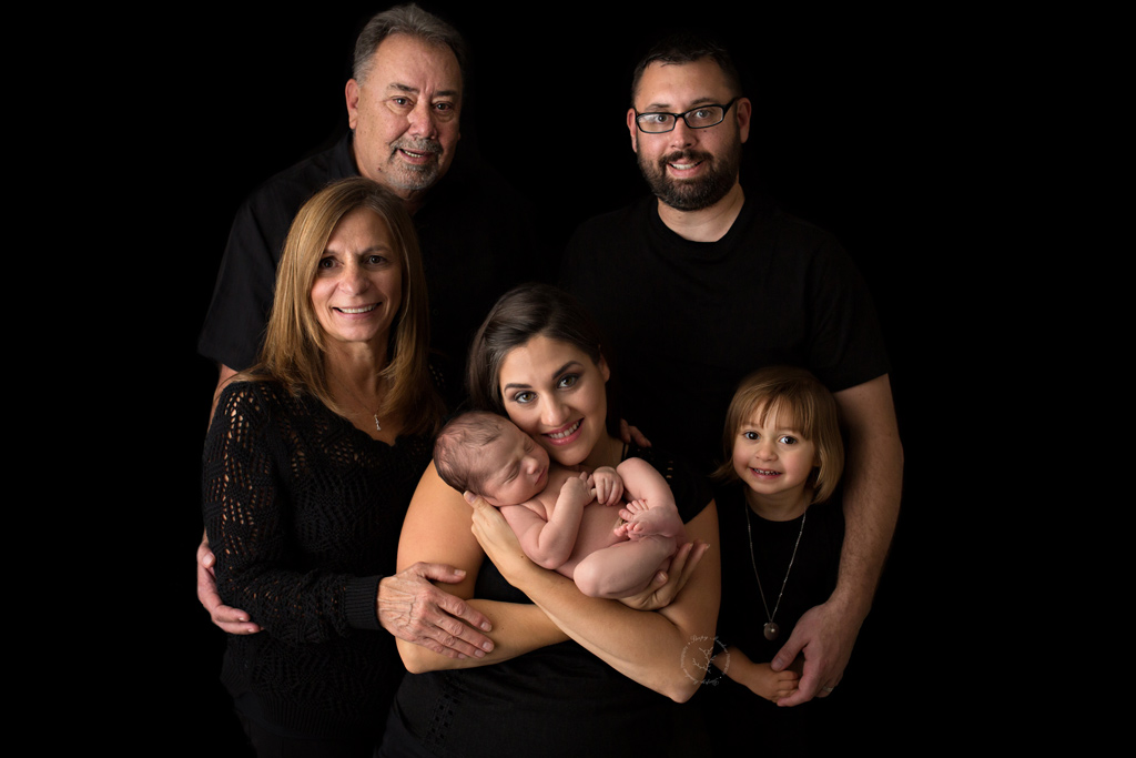 One of the best newborn pictures taken of baby's parents, sibling and grandparents.