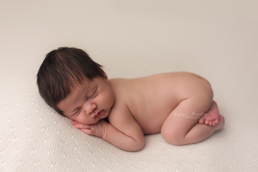 Newborn pictures of baby boy with a head full of beautiful dark hair by Sleepy Meadow Photography | Milwaukee's Best Newborn Photographer