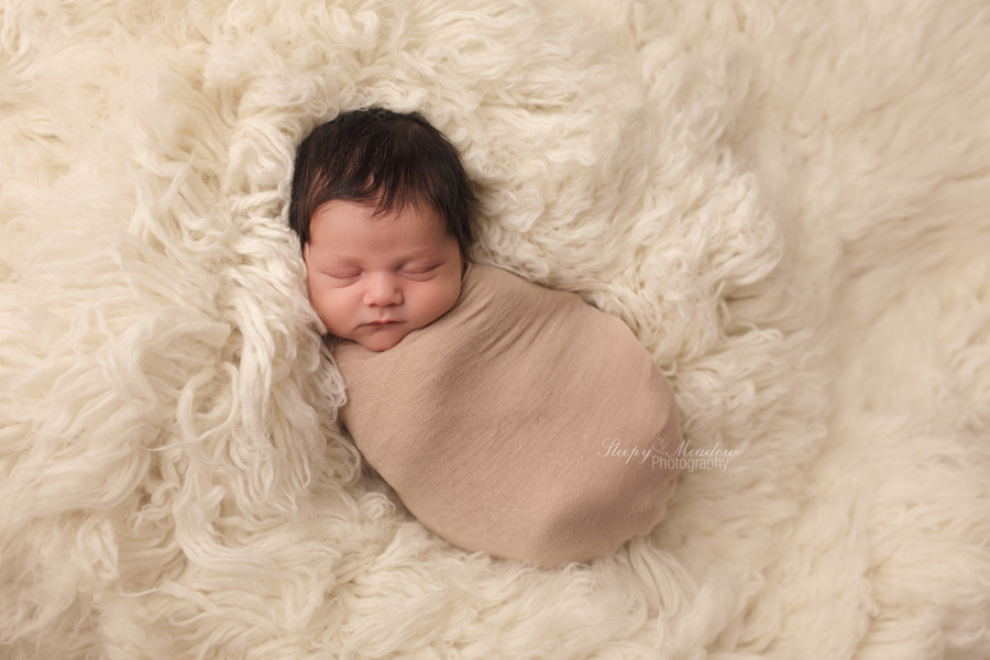 Baby boy wrapped snuggly for his newborn session in Waukesha, WI with Sleepy Meadow Photography.