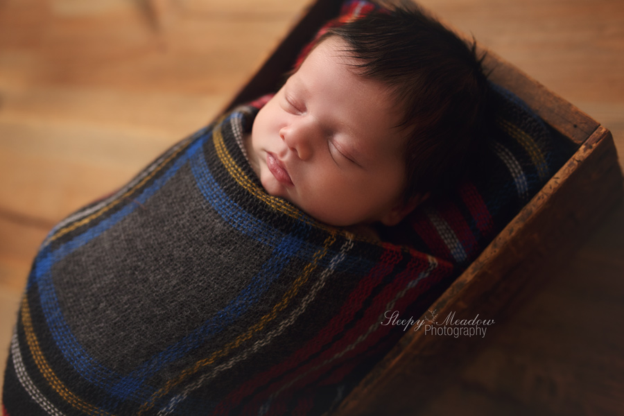 Rustic newborn session on wood backdrop taken by Sleepy Meadow Photography of Waukesha, Wisconsin.