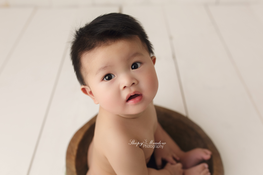 Adorable baby boy takes pictures in a vintage bowl at Sleepy Meadow Photography.