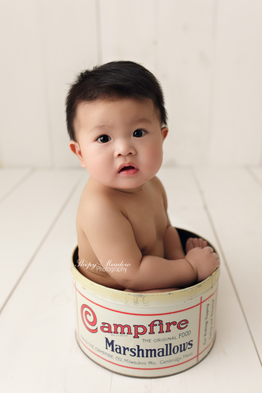 Sweet baby boy poses in vintage tin for his photo shoot in Waukesha.