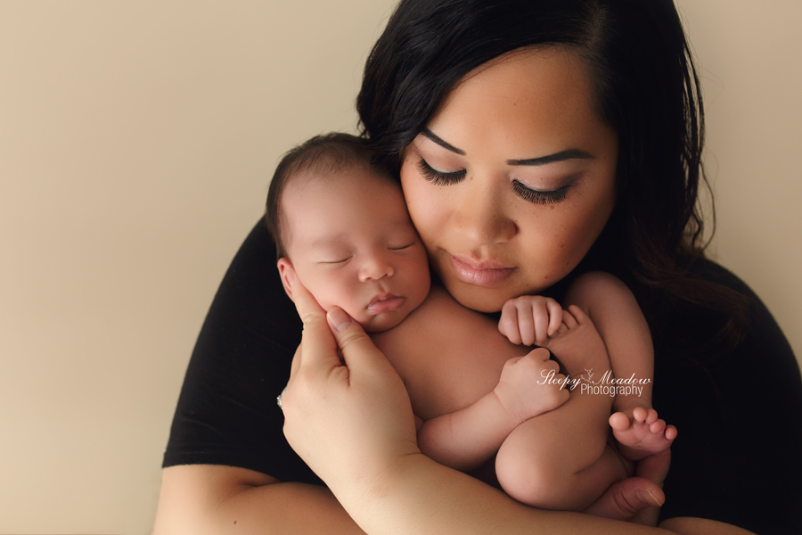 Mom and baby pose for their newborn session in Waukesha with Sleepy Meadow Photography.
