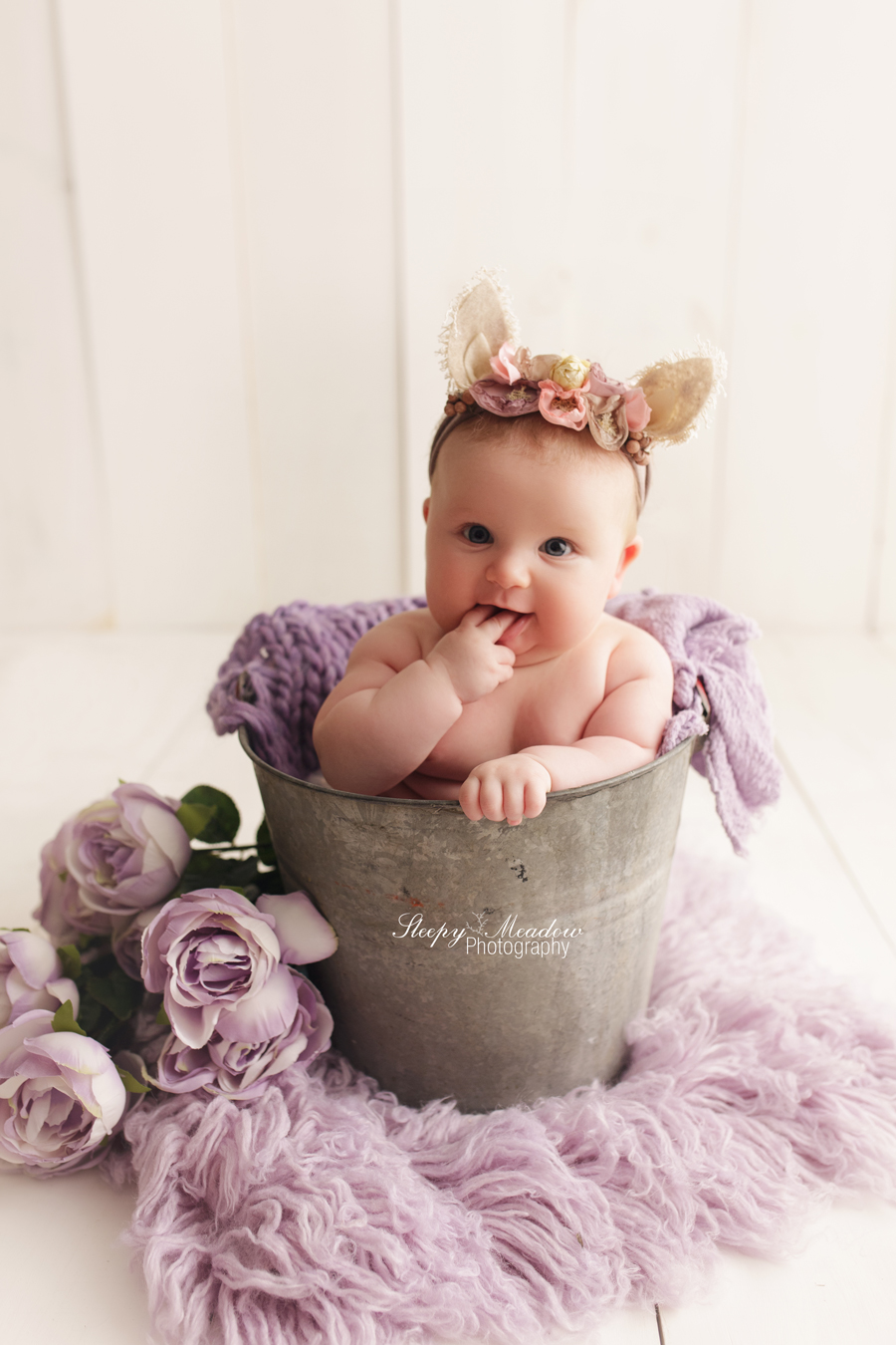 Cute baby girl poses in vintage bucket with flowers. Sleepy Meadow Photography | Milwaukee Baby Photographer