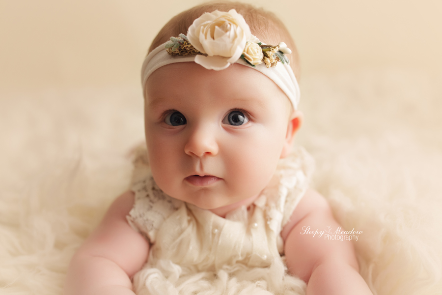 Blue eyed baby girl photographed by Milwaukee portrait artist at Sleepy Meadow Photography.