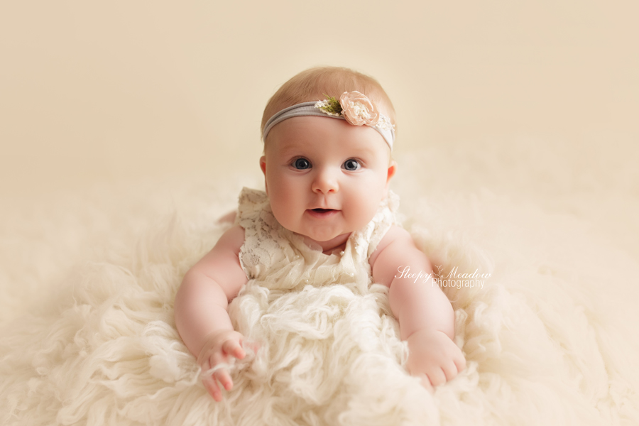 Baby girl wears an adorable headband for her 4 months session in Milwaukee by Sleepy Meadow Photography.