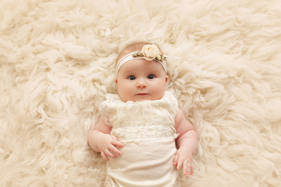 4 month old photographed on ivory rug in Waukesha.