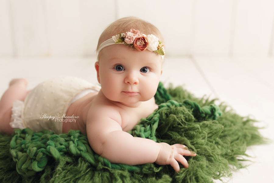 Waukesha baby photographed on a green Luneberry flokati prop for her 4 month old session at Sleepy Meadow Photography.