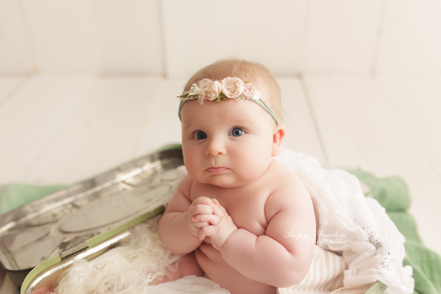 4 month old photographed in vintage tin at Milwaukee photography studio.