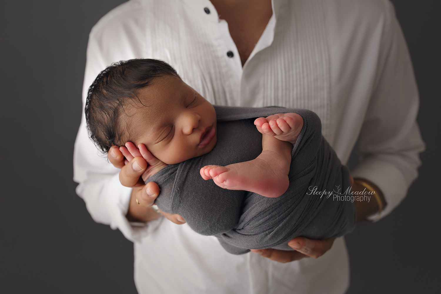 Look how tiny Kiansh looks in his newborn session posing with his dad. | Newborn photos by Sleepy Meadow Photographer