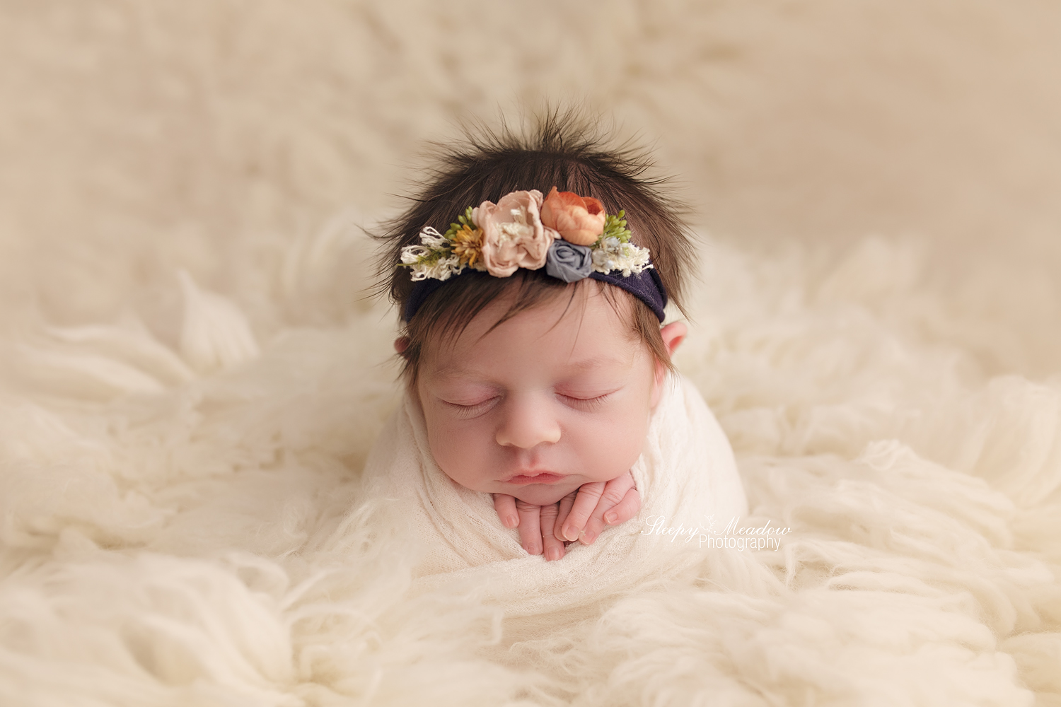 Baby girl with head full of hair in potato sack pose for her newborn session. | Newborn session by Sleepy Meadow Photography