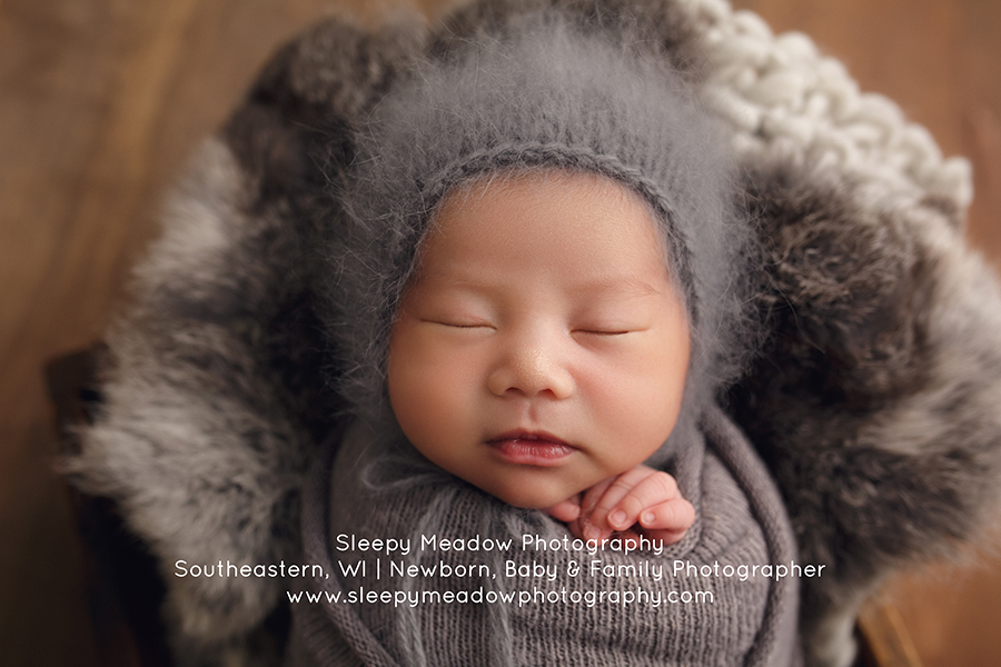 Baby poses on soft gray props by Sleepy Meadow Photography | Waukesha Newborn Photographer