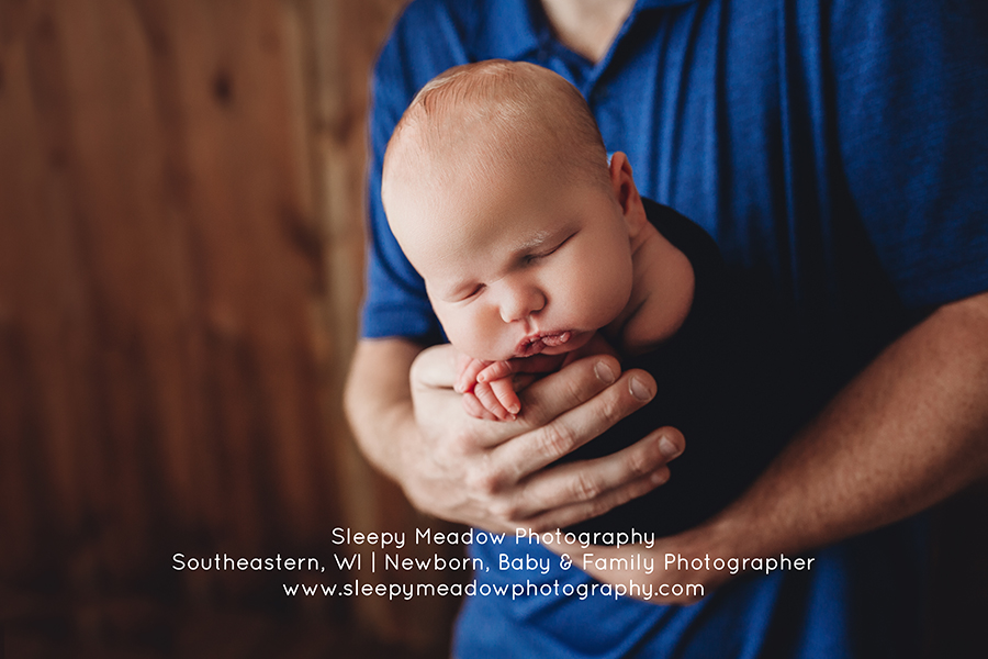 baby in dads hands | Newborn Photography Brookfield