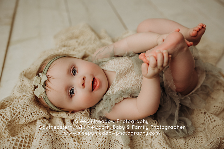 7 month old grabbing her toes for photoshoot | Cedarburg baby photoshoot