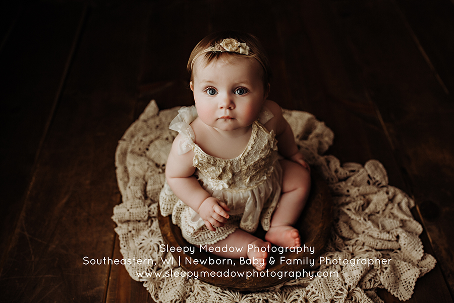 Baby posing in a bowl for her photoshoot at Sleepy Meadow Photography
