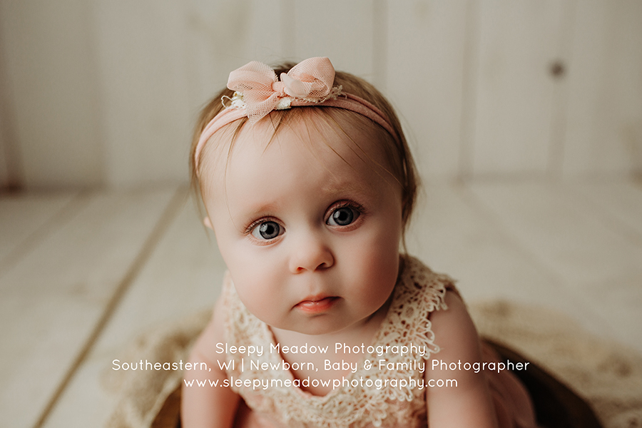 Sweet baby girl wearing pink headband | Whitefish Baby Pictures