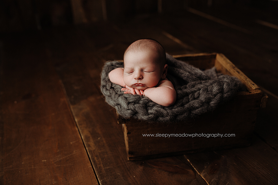 baby posing in vintage wooden box